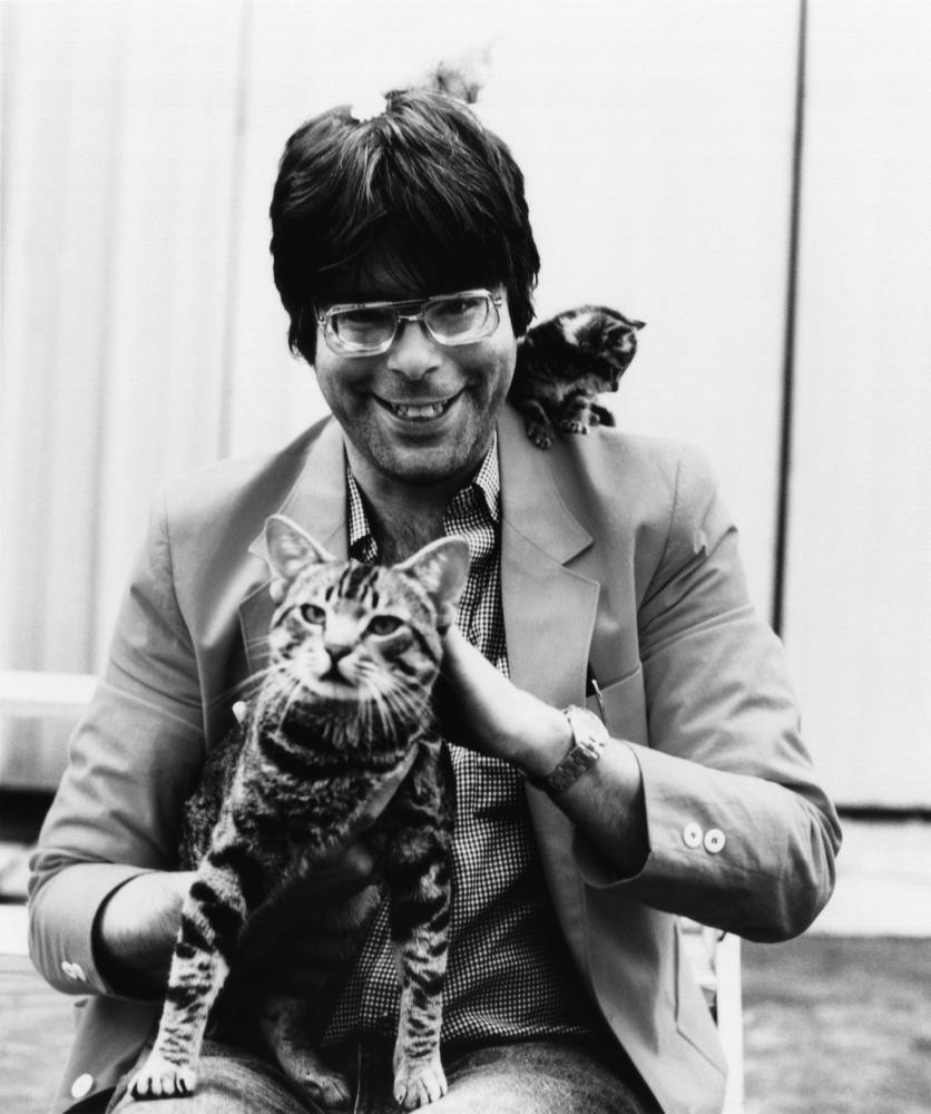 Stephen King peering over his glasses, with &quot;Cat's Eye Stephen King&quot; text overlay