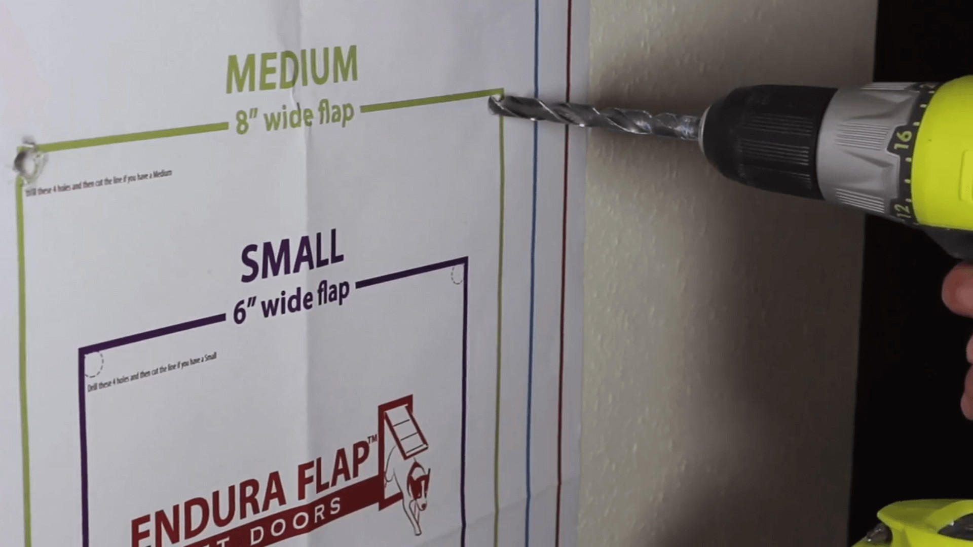 Image showing paper template guides for drilling holes for cat door installation.