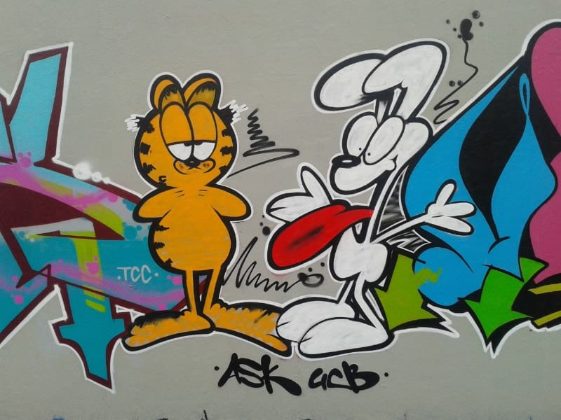 Garfield, the iconic animated orange tabby cat known for his love of lasagna, as seen in various cartoon adaptations.