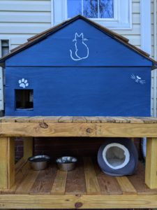Decorative paint touches added to the DIY cat house