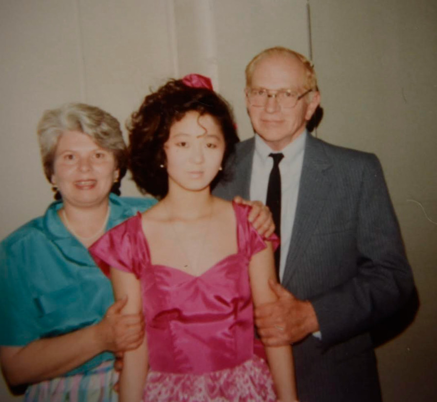 Cat Powell-Hoffmann with adoptive parents at her eighth-grade graduation.