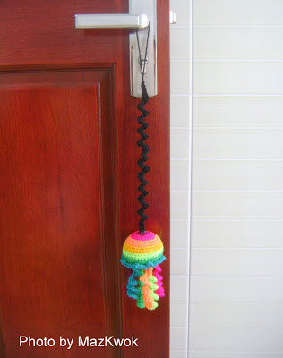Colorful rainbow jellyfish crochet cat toy hanging, designed for interactive play