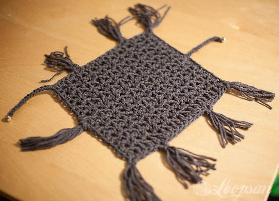Small crochet blanket cat toy with tassels, designed for cats to drag and play with