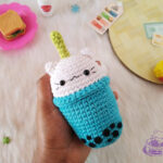 Close-up of a boba cat amigurumi cup being crocheted in pink yarn.
