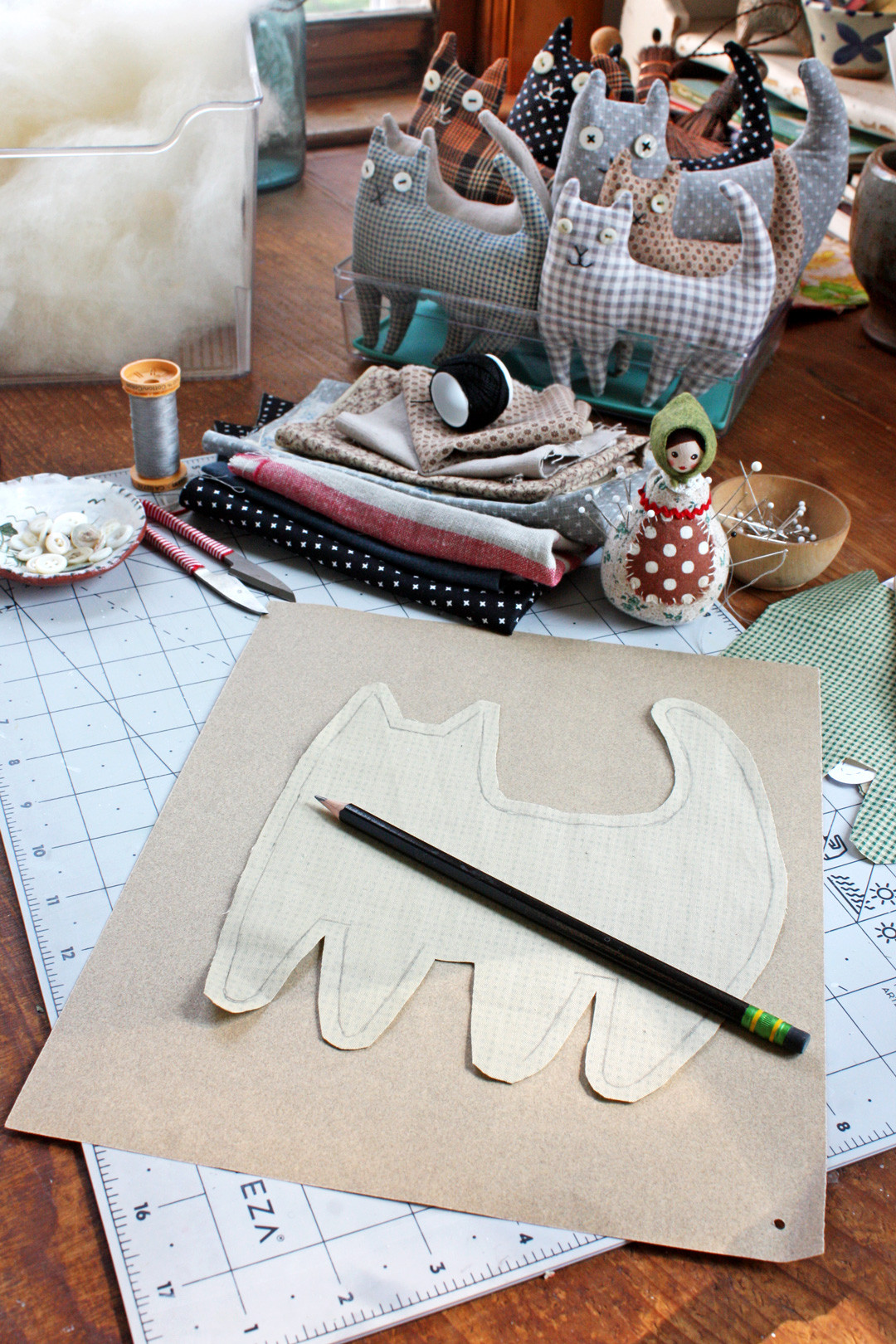 Marking the seam allowance for the happy cat sewing pattern with a pencil.