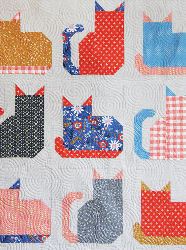 Detailed quilting on the Kitty Cats Quilt, showcasing a unique 'ball of yarn' quilting pattern done by Kaitlyn, adding a playful touch to this kitty cat themed quilt.