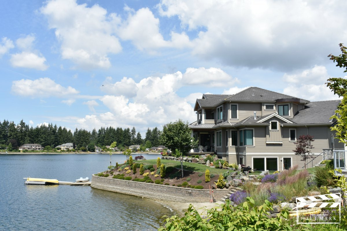 Exterior view of the lakeside house from Cats &amp; Dogs film, emphasizing its beautiful setting and outdoor features