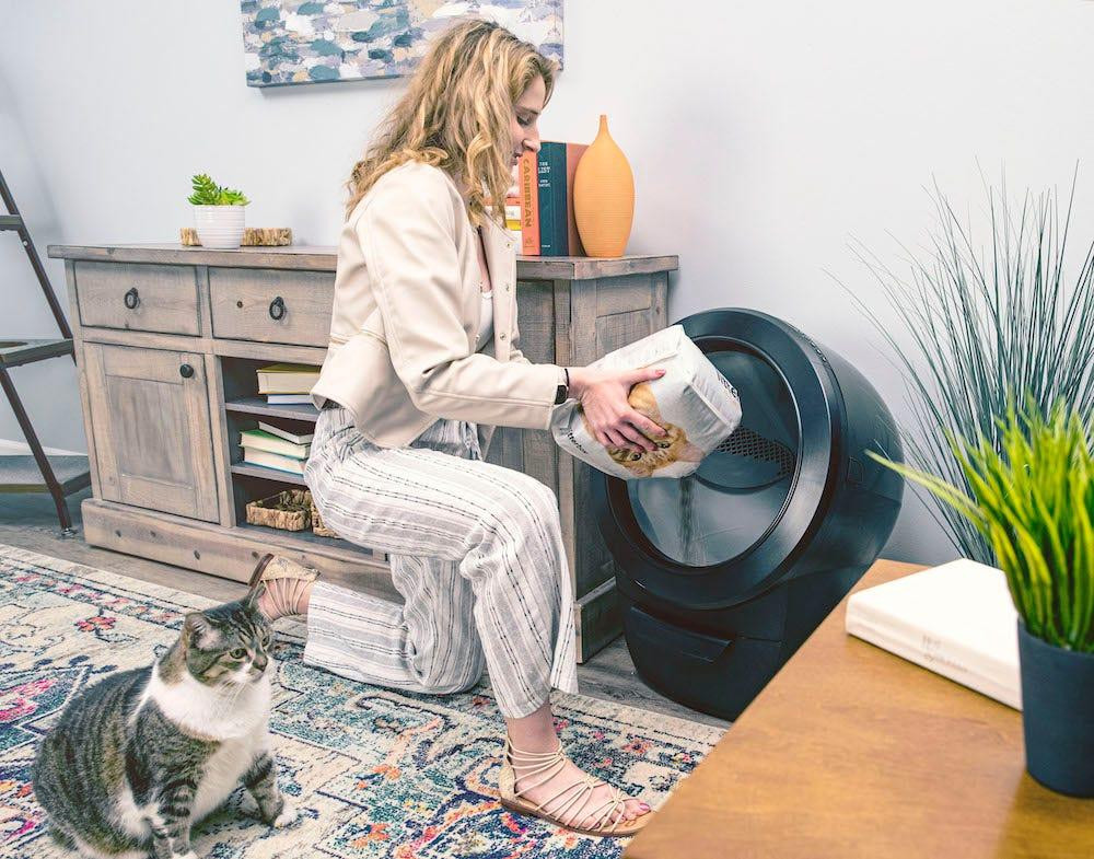 woman adding premium clumping litter, the best cat litter for Litter-Robot 4