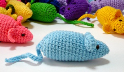 Close up of crochet mouse cat toy showing details like ears and tail, stuffed with catnip