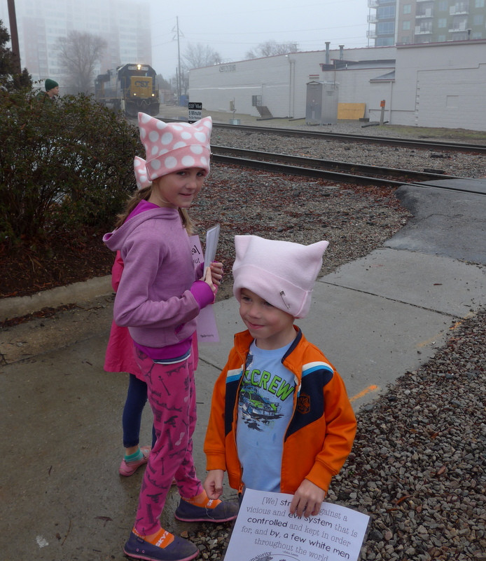 Family waiting for train at Women's March