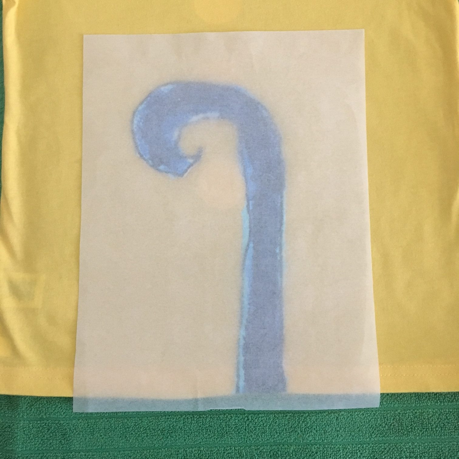 Ironing on Pete the Cat tail on the back of the shirt