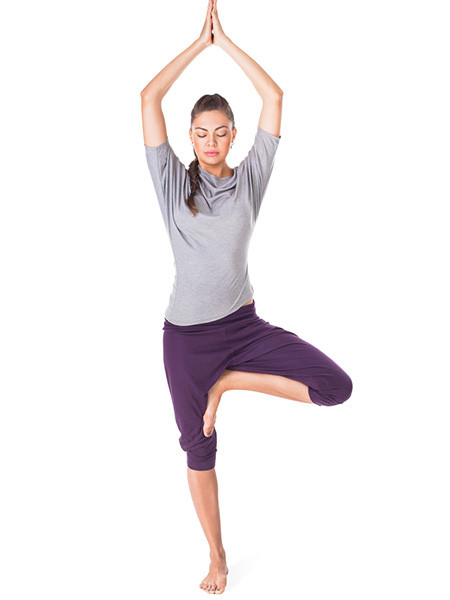 Person balancing in tree pose during yoga practice. Woman demonstrating tree pose for balance.