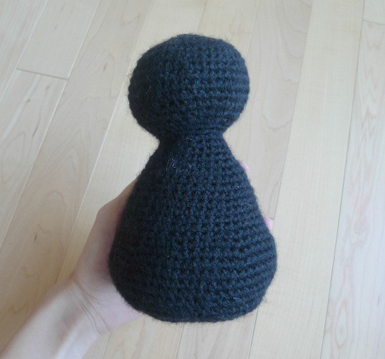 Holding the crocheted Jiji body to show the size and progress of the amigurumi