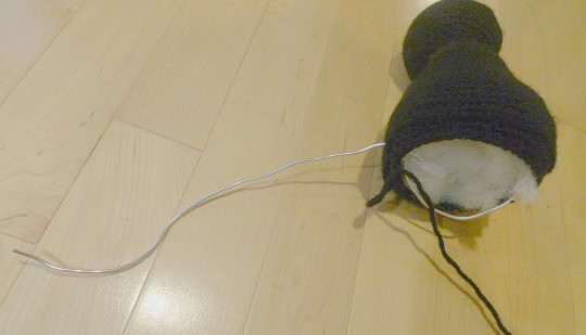 Preparing to add a poseable wire structure to the Jiji amigurumi for the tail