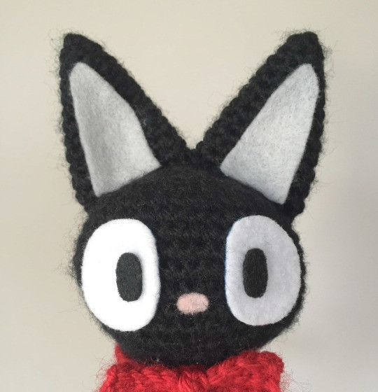 Adding felt details to the Jiji amigurumi to create the face and ears