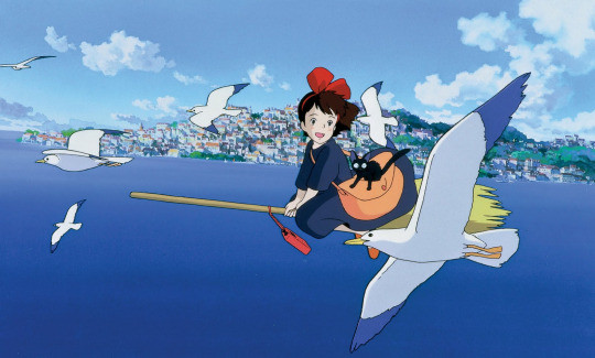 Kiki and Jiji flying on a broomstick, showcasing the main characters of Kiki's Delivery Service
