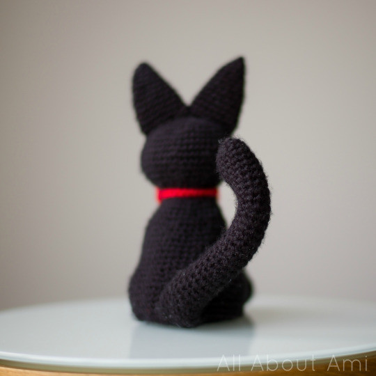 Poseable tail of the Jiji amigurumi being bent, showing the flexibility added by wiring