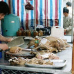 Dogs being butchered in Guangdong, China in 1999, highlighting the historical practices of the dog meat trade