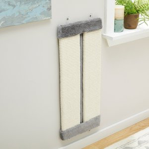 Cat using a wall-mounted scratching pad