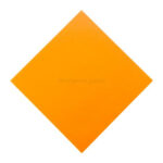 The back side of the origami paper, typically white, facing upwards on a flat surface