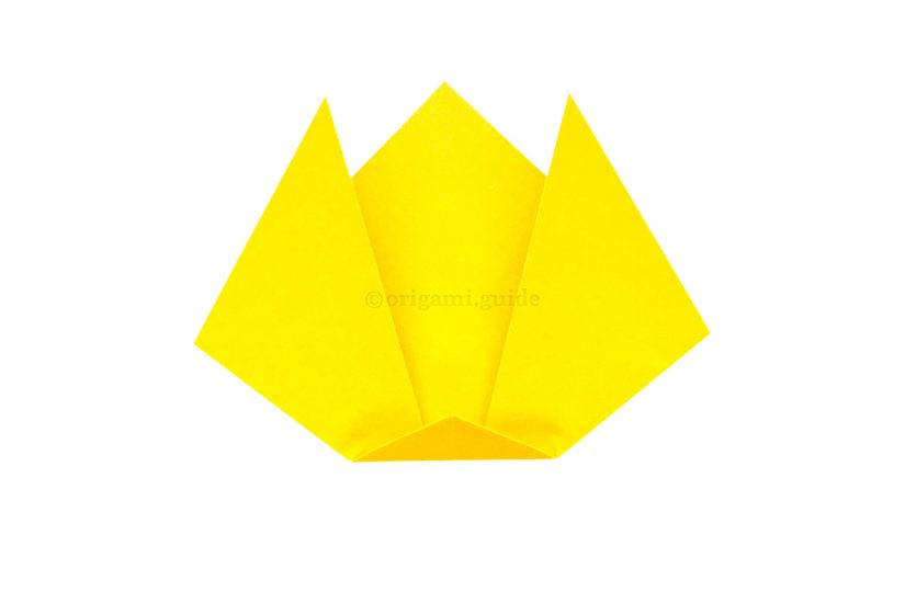 Folding the bottom point upwards to create the cat's chin