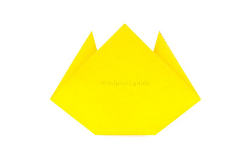 Flipping the origami cat face over to reveal the completed model