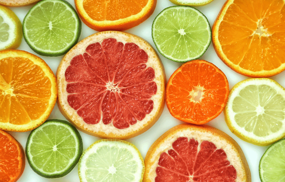 A variety of vibrant citrus fruits, including oranges, lemons, limes, and grapefruits, known for their scents that cats typically dislike